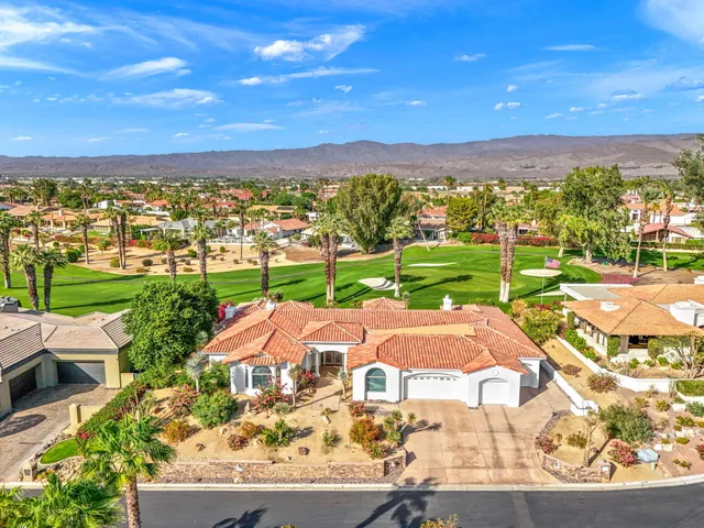 an aerial view of residential houses with outdoor space and street view
