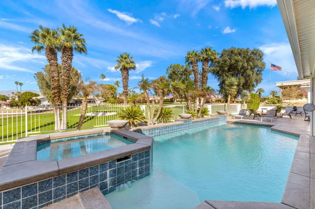 a view of a lake with couches and city view