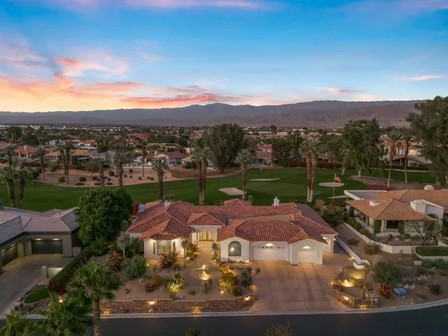 a view of a swimming pool with outdoor seating