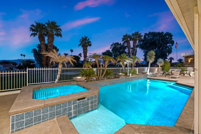 a view of a patio with swimming pool table and chairs