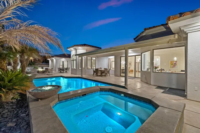 a view of a swimming pool with chairs