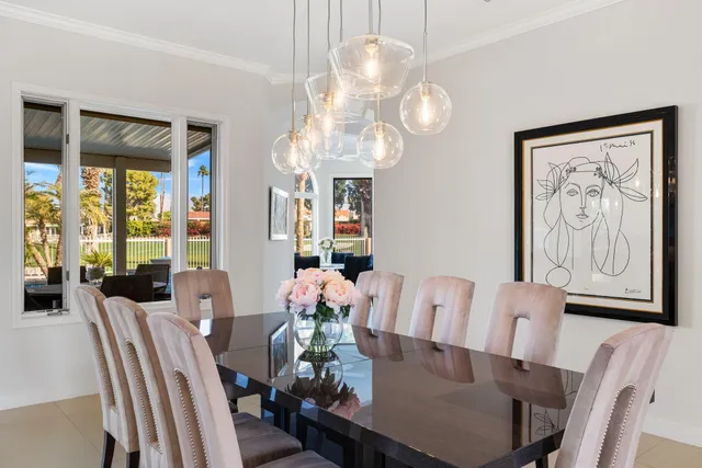 a dining room with furniture a chandelier and window