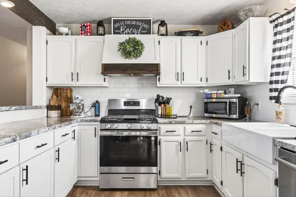 a kitchen with cabinets appliances and a sink