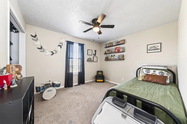 a bedroom with a bed and a chandelier