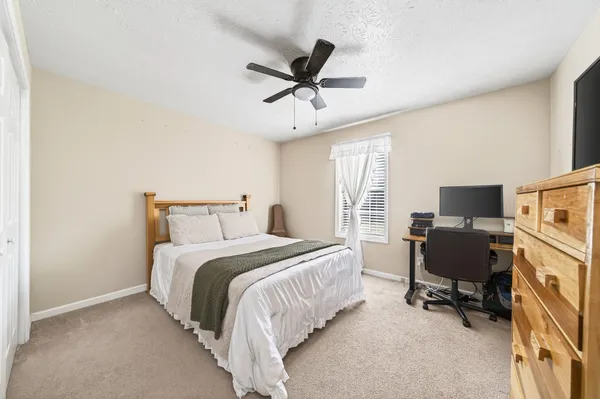 a bedroom with a bed and a desk