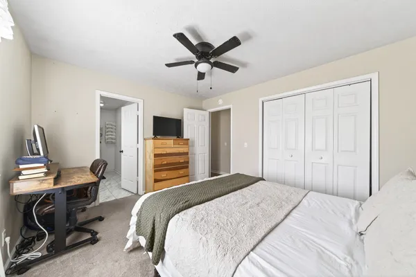 a bedroom with a bed and a desk