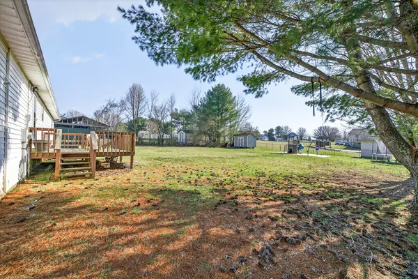 a view of a chair and table in backyard