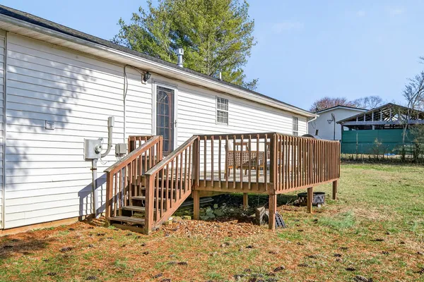 a view of outdoor space with deck and yard