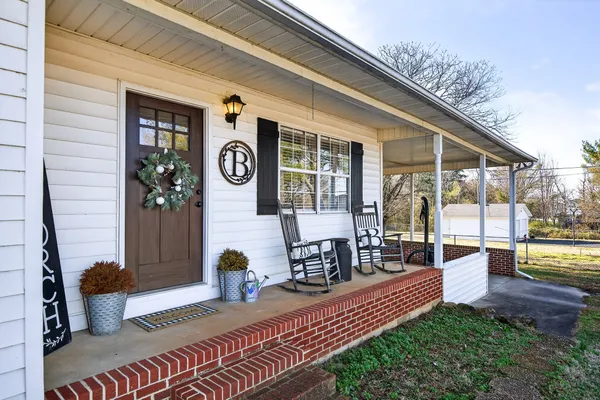 a view of a porch with furniture and garden