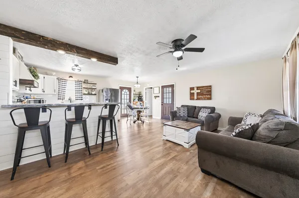 a living room with furniture and wooden floor