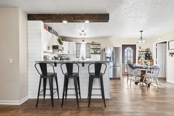a dining area with furniture window and wooden floor