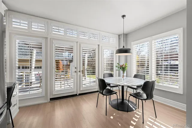 a view of a dining room with furniture window and wooden floor