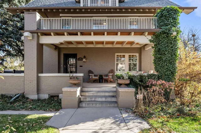 a front view of a house with garden and plants