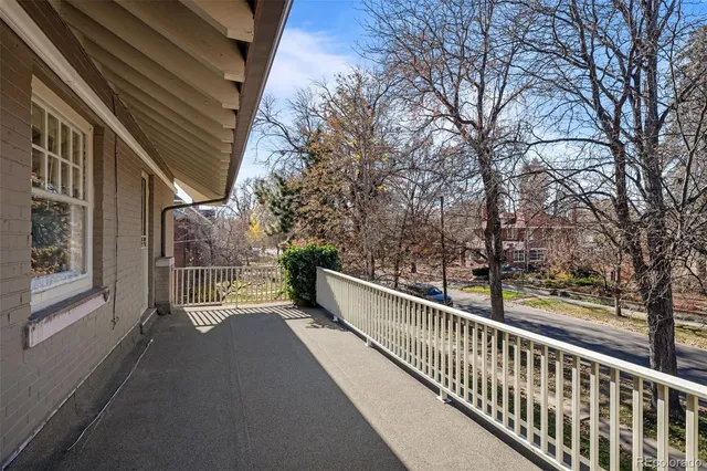 a view of a balcony with trees