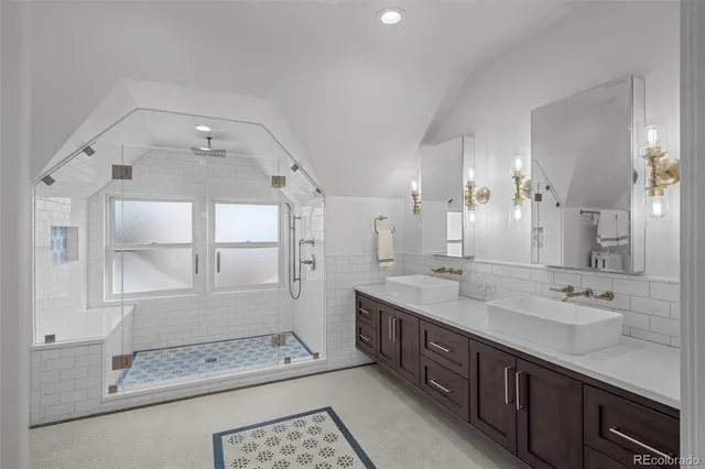 a spacious bathroom with double sink and a mirror