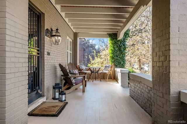 a view of a patio with table and chairs with wooden floor and fence