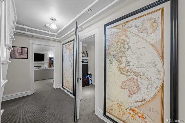 a view of a kitchen with wooden floor and a refrigerator