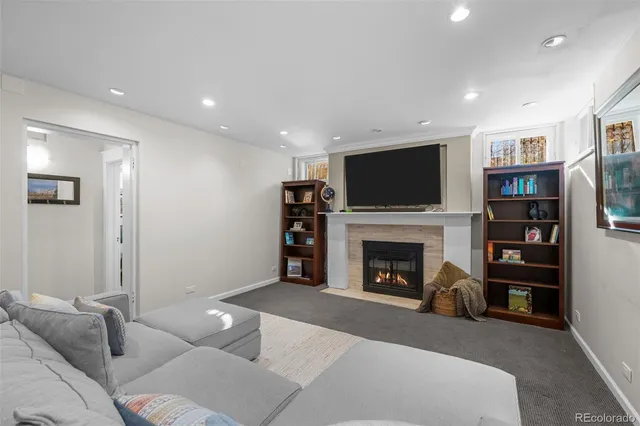 a living room with furniture a fireplace and a flat screen tv