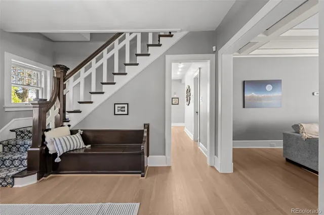 a view of entryway and hall with wooden floor