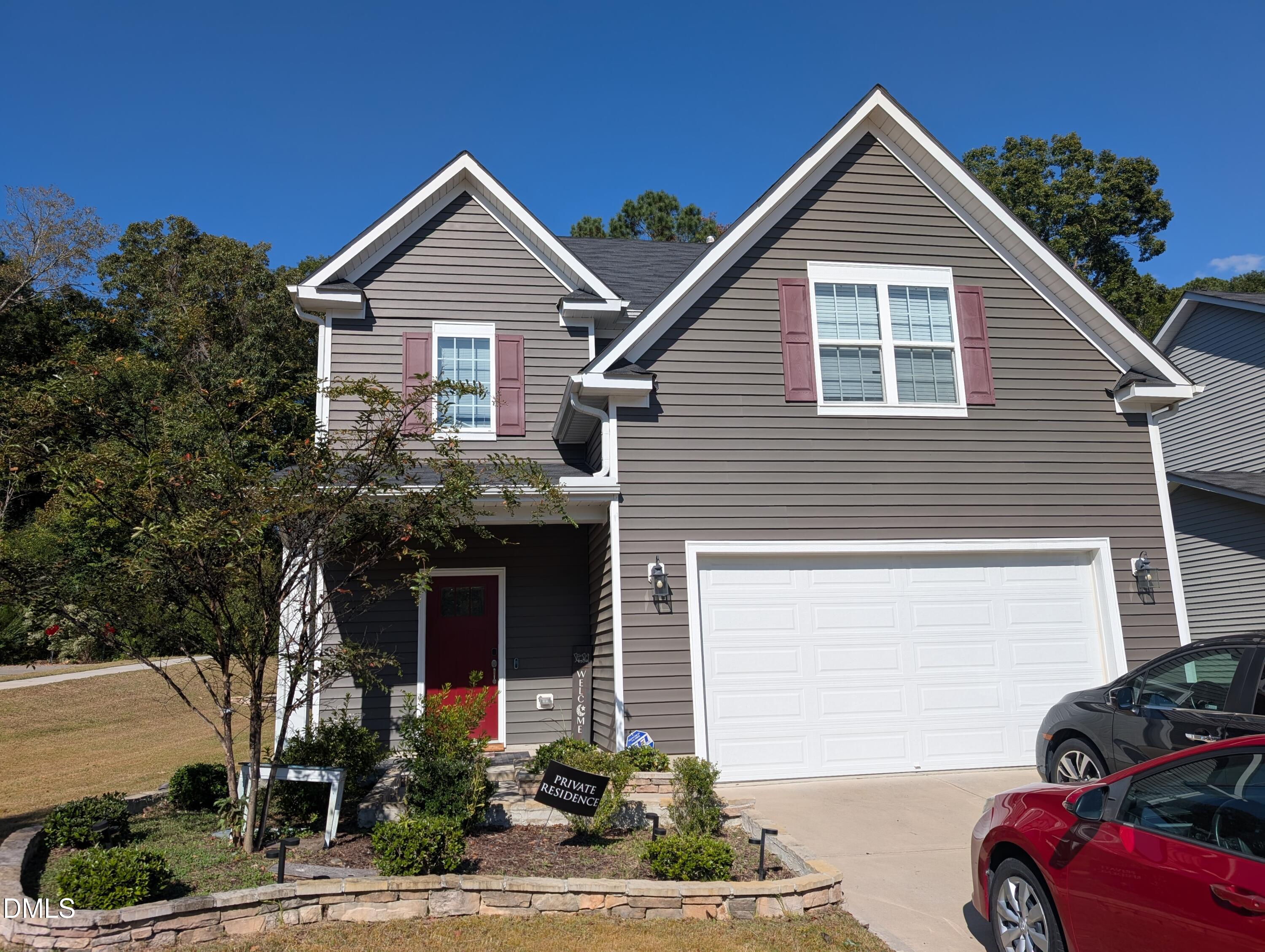 a front view of a house with garage