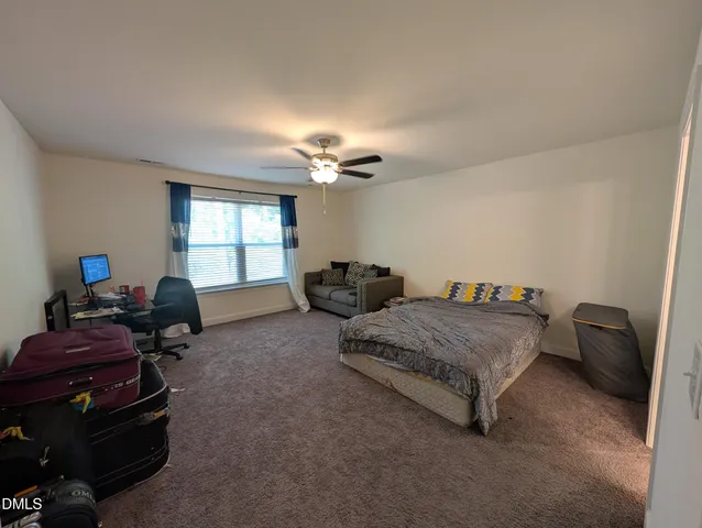 a bedroom with bed and a window