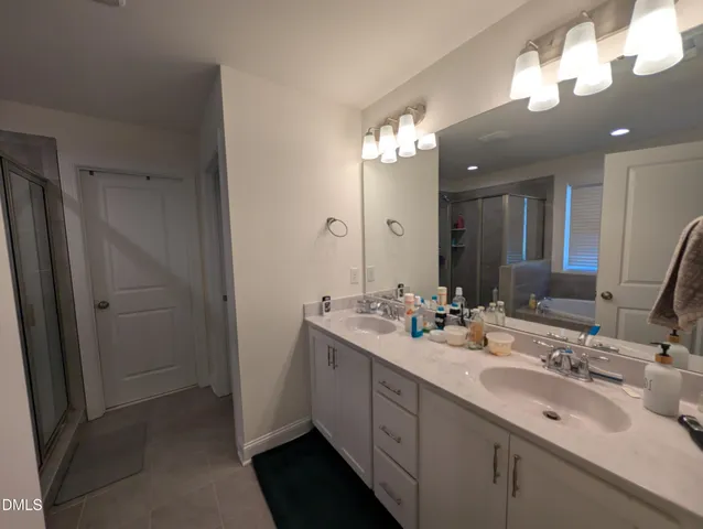 a bathroom with a double vanity sink and a mirror