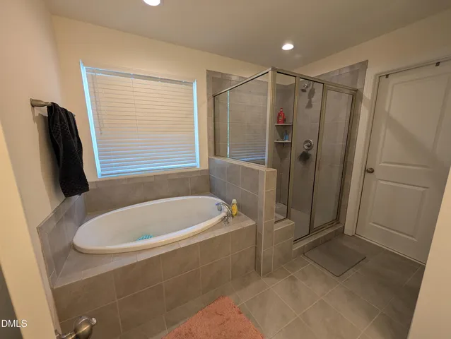 a bathroom with a tub a toilet and a shower