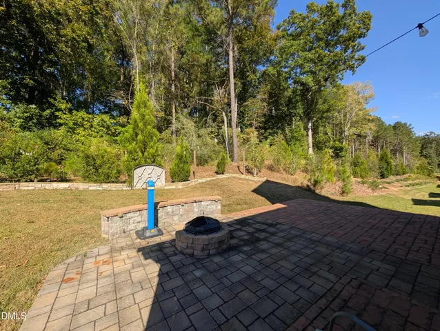 a view of yard with swimming pool and green space