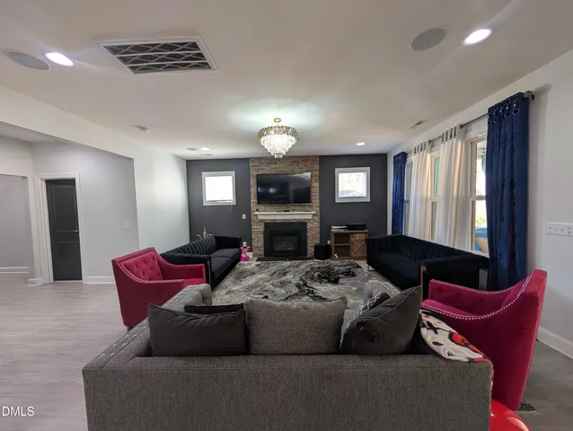 a living room with furniture wooden floor and window