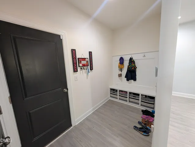 a view of a livingroom with wooden floor and windows
