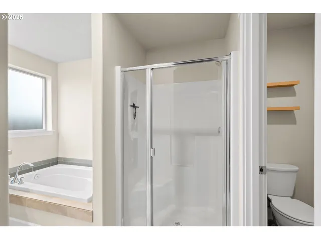 a view of walk in closet with clothes