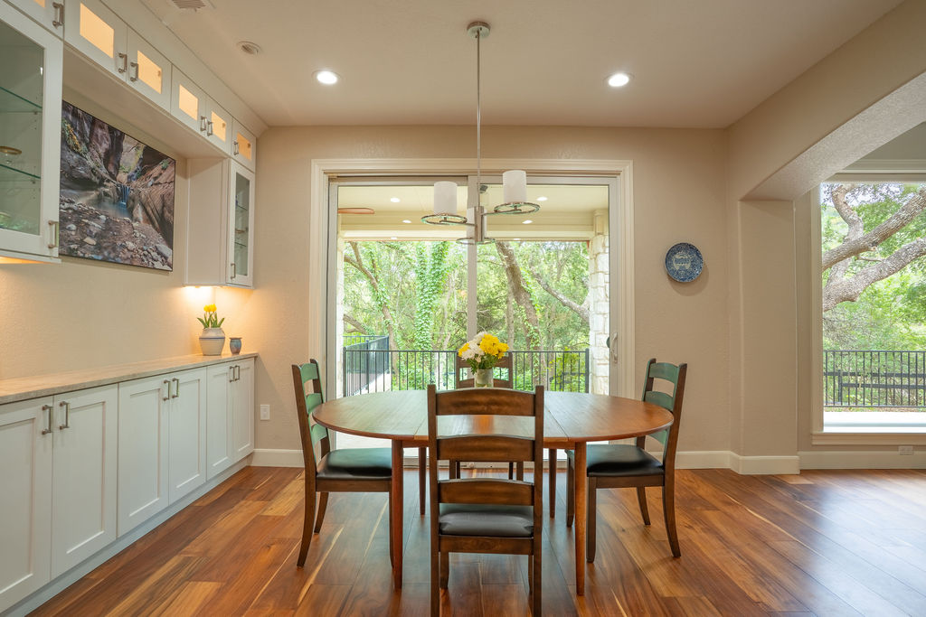 13800 Lone Rider Trail Austin, TX 78738 - Photo 9 of 27 a dining room with furniture a chandelier and wooden floor