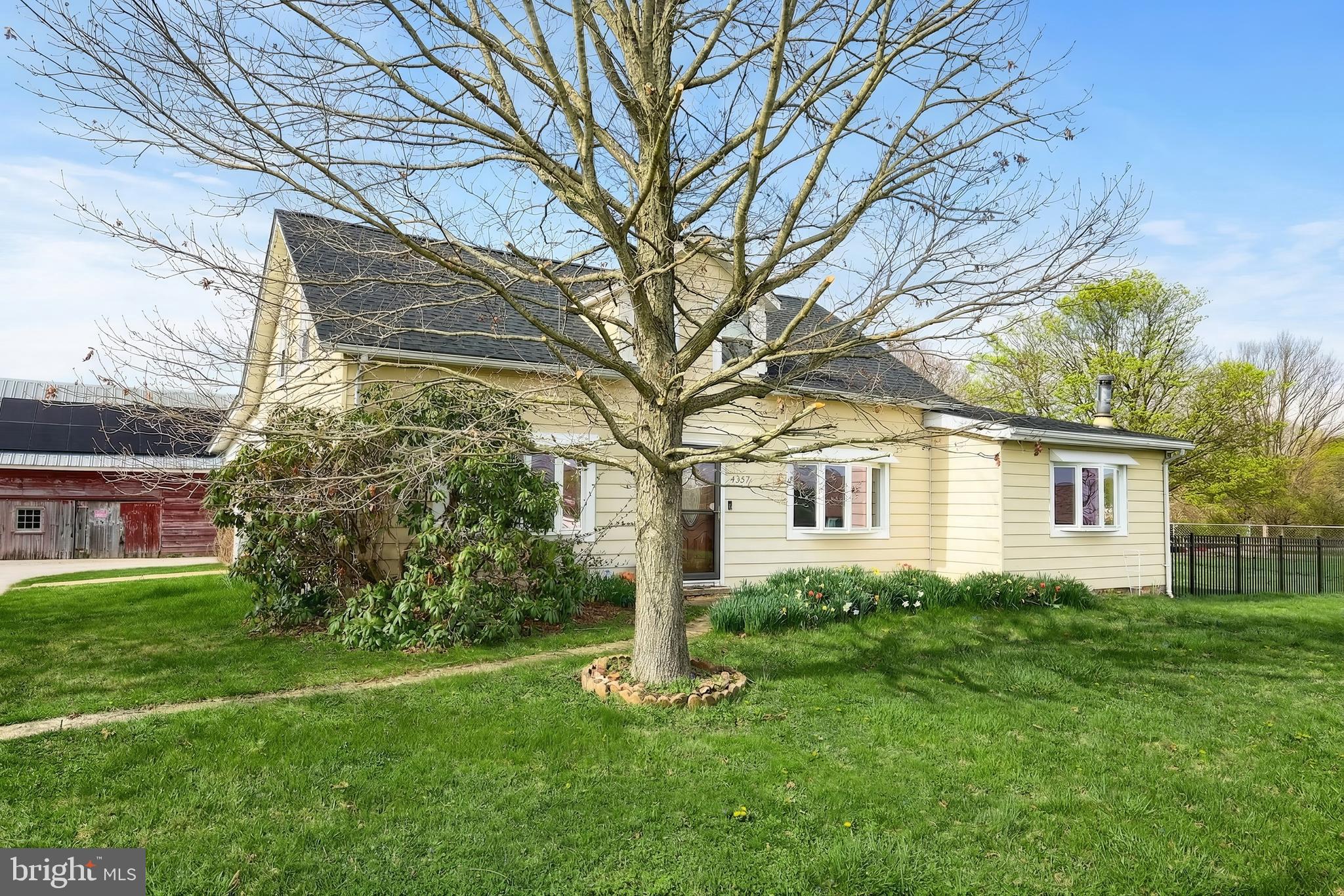 a house that has a tree in front of a house