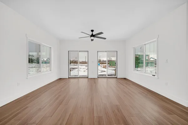a view of empty room with wooden floor