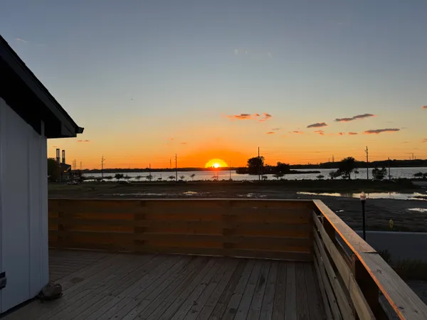 a view of a kitchen with a sink and a refrigerator