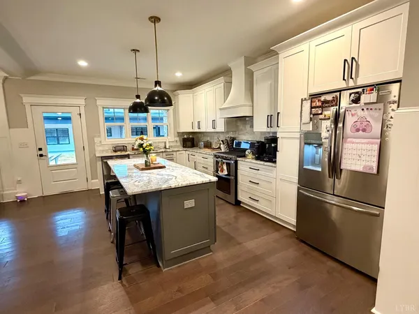 a stove top oven sitting inside of a kitchen