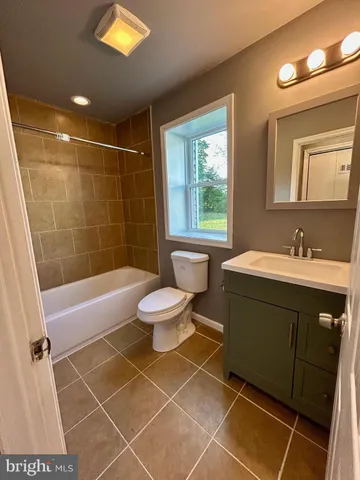 a bathroom with a toilet a sink and bathtub