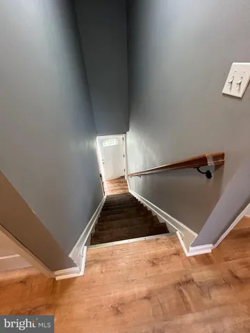 a view of a big room with wooden floor and windows