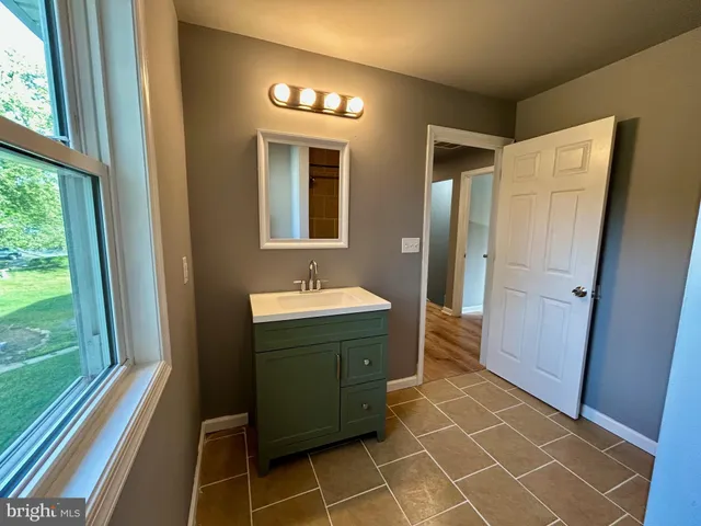 a bathroom with a bathtub and window