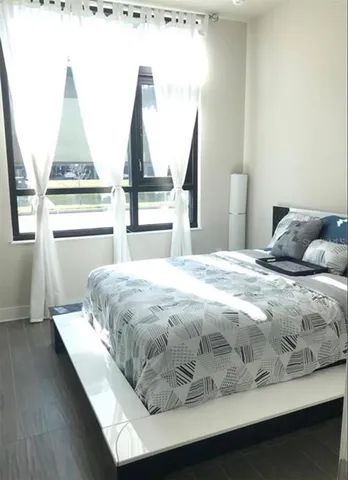 a bedroom with a bed and window