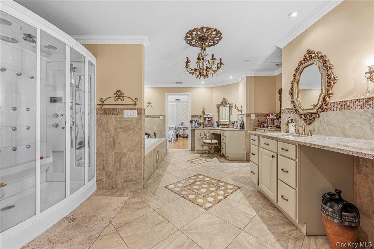 626 Caledonia Road Dix Hills, NY 11746 - Photo 31 of 49 a kitchen with a sink a refrigerator and cabinets