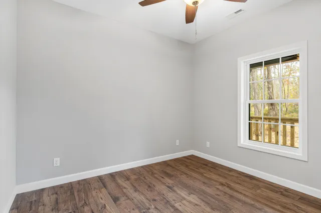 wooden floor in an empty room with a window