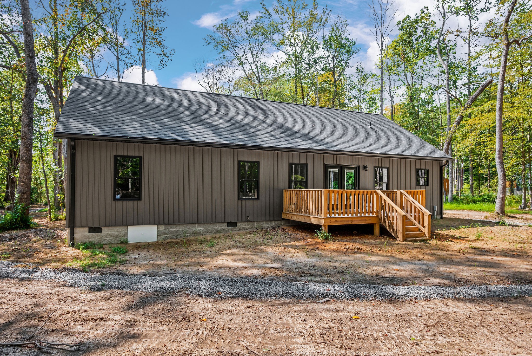 179 Park Road Rickman, TN 38580 - Photo 28 of 29 a view of a house with a yard and lawn chairs under an umbrella