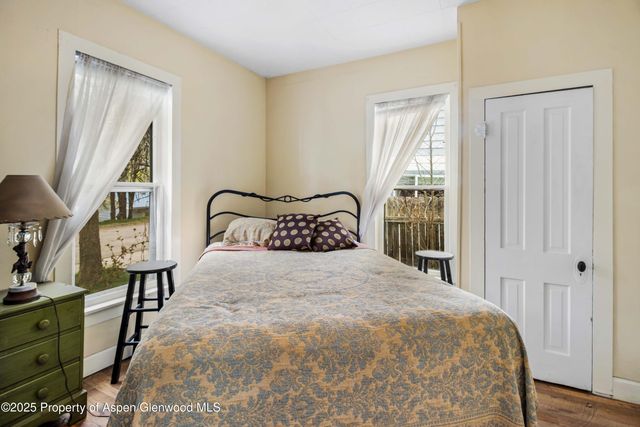 a bedroom with a bed and a mirror