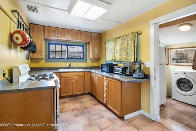 a kitchen with a sink and a stove top oven