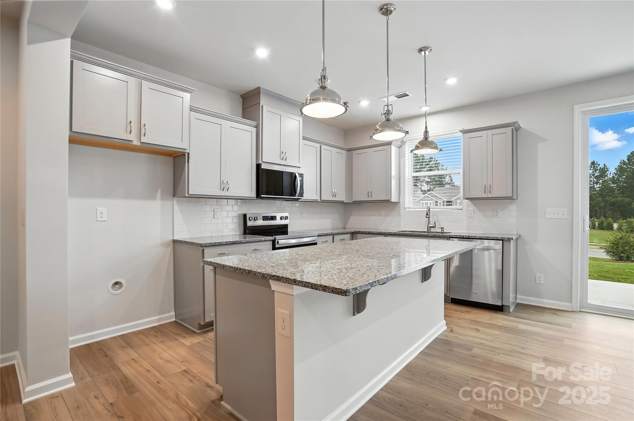 637 Cassidy Court Clover, SC 29710 - Photo 1 of 25 a kitchen with kitchen island granite countertop a sink a counter space appliances and cabinets