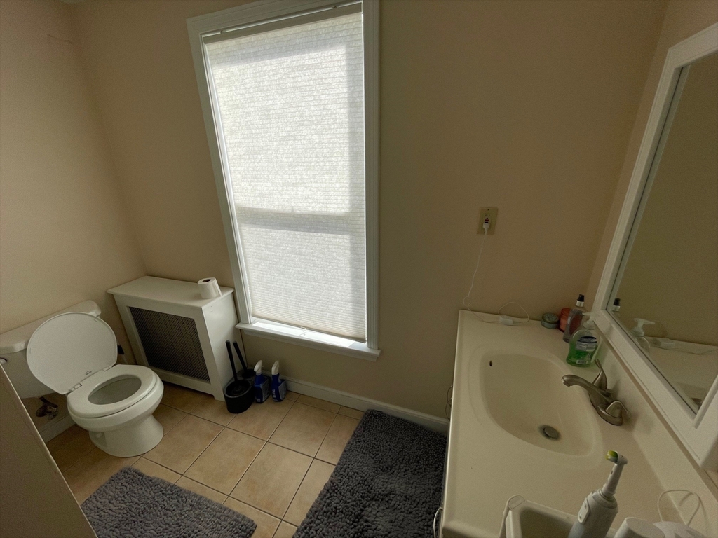 550 Main Street, Unit 2 Woburn, MA 01801 - Photo 11 of 14 a bathroom with a sink and a toilet