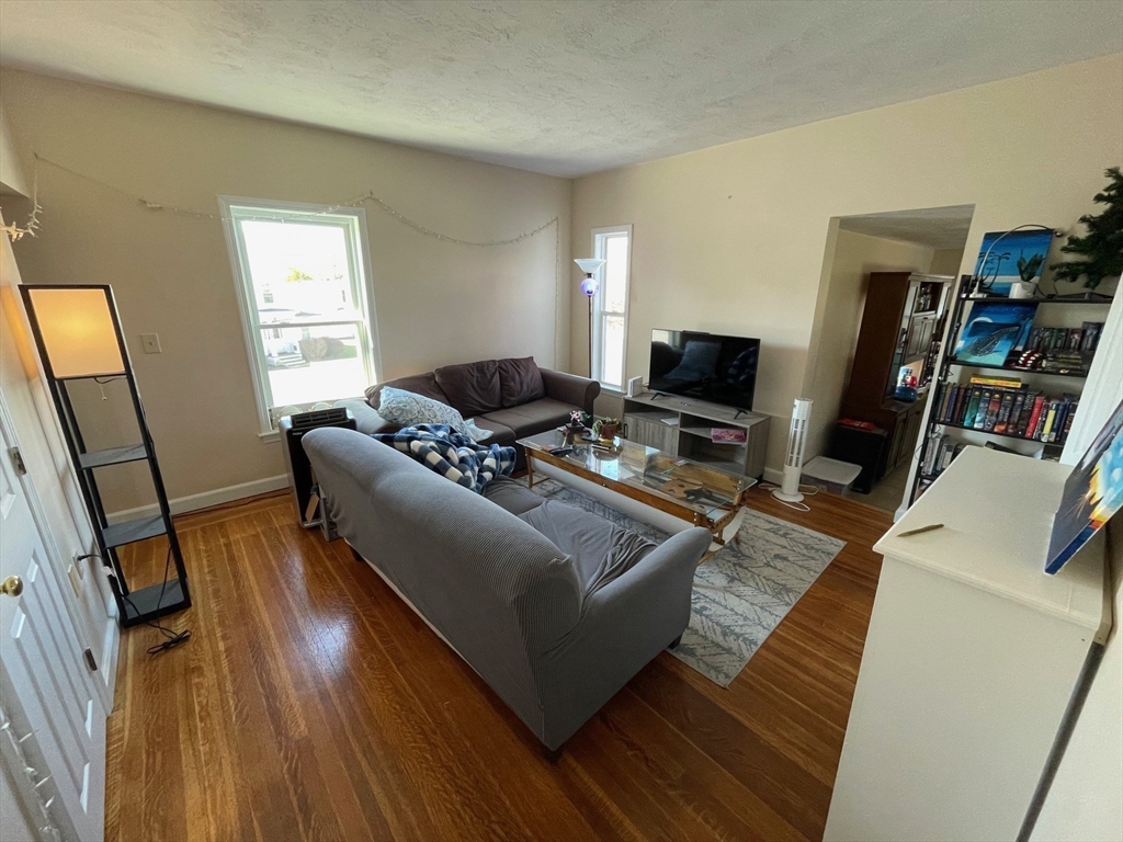 550 Main Street, Unit 2 Woburn, MA 01801 - Photo 2 of 14 a living room with furniture and a flat screen tv