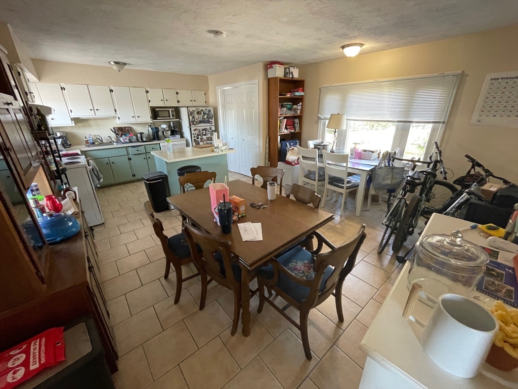550 Main Street, Unit 2 Woburn, MA 01801 - Photo 4 of 14 a view of a dining room with furniture and a kitchen