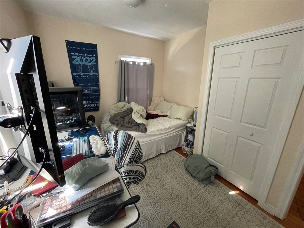 550 Main Street, Unit 2 Woburn, MA 01801 - Photo 9 of 14 a living room with furniture and a flat screen tv
